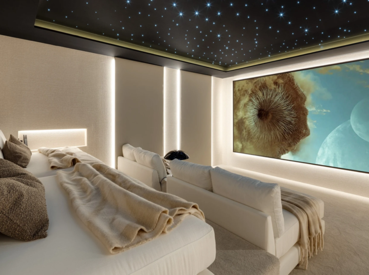 Private cinema with tiered seating and a star-effect ceiling
