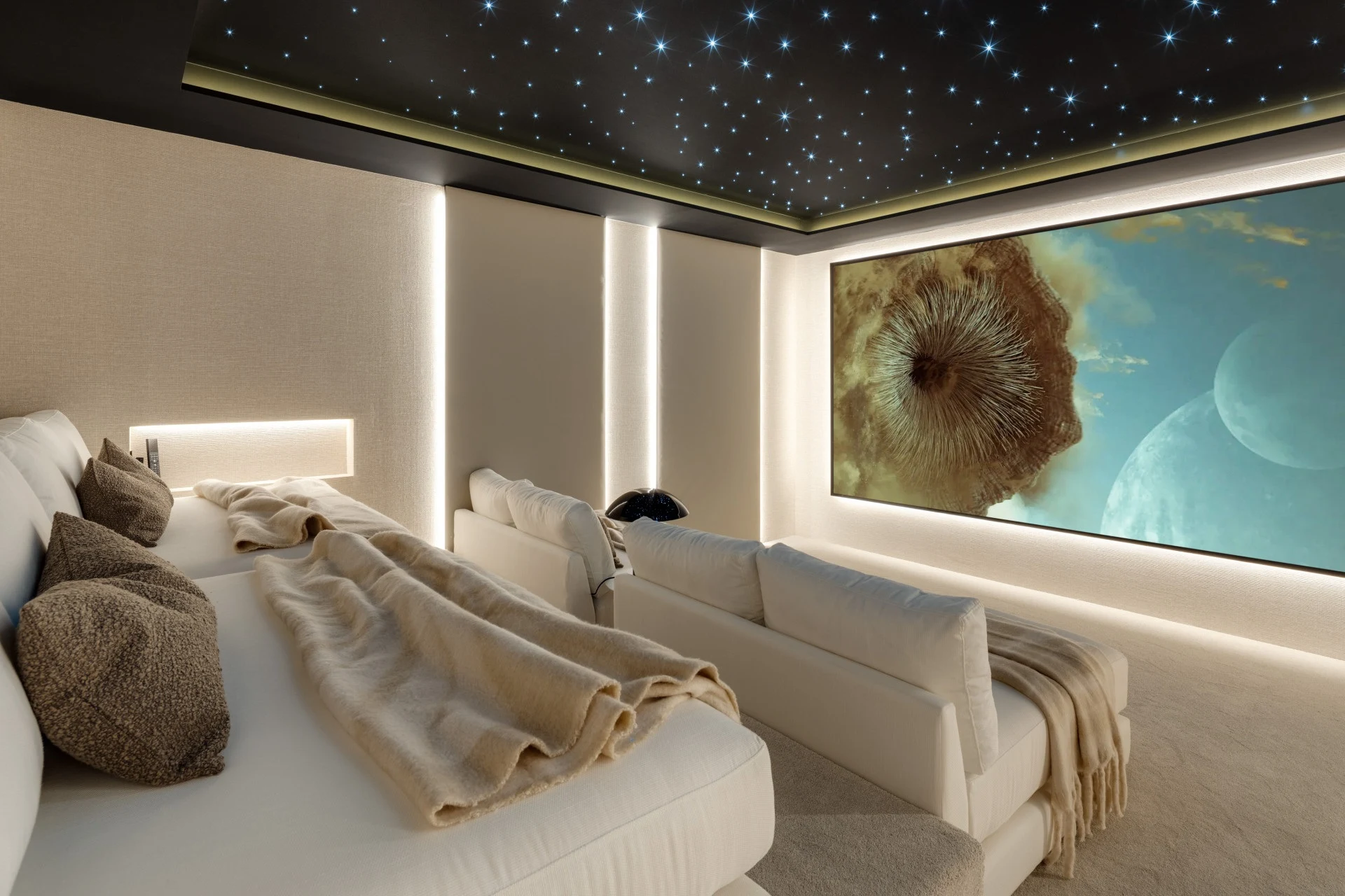 Private cinema with tiered seating and a star-effect ceiling