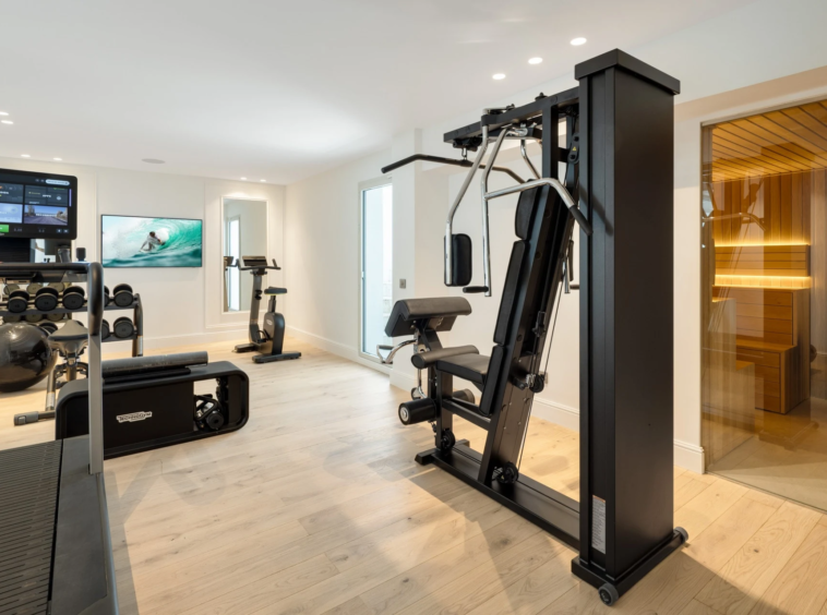 Home gym with exercise machines and sauna access