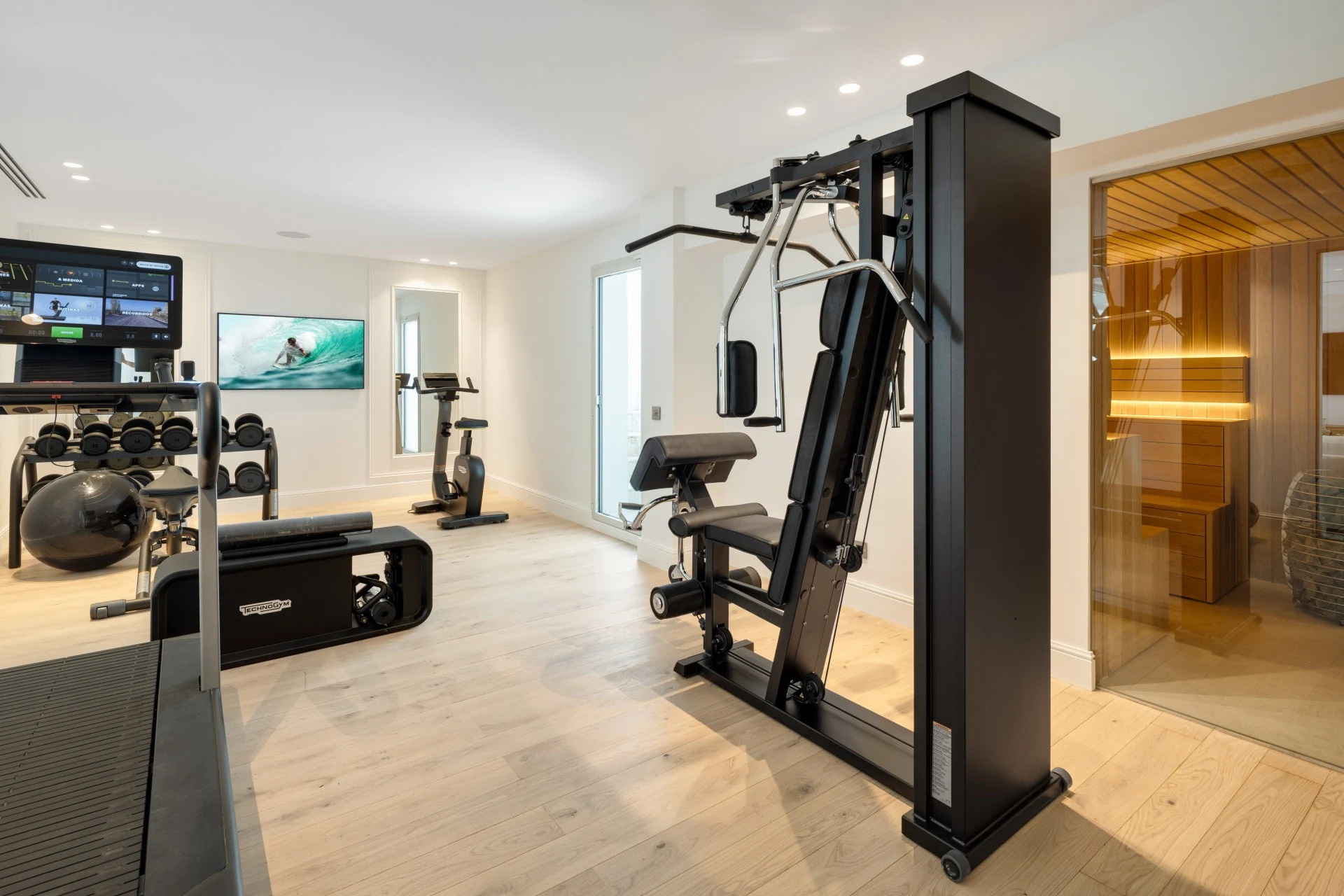 Home gym with exercise machines and sauna access