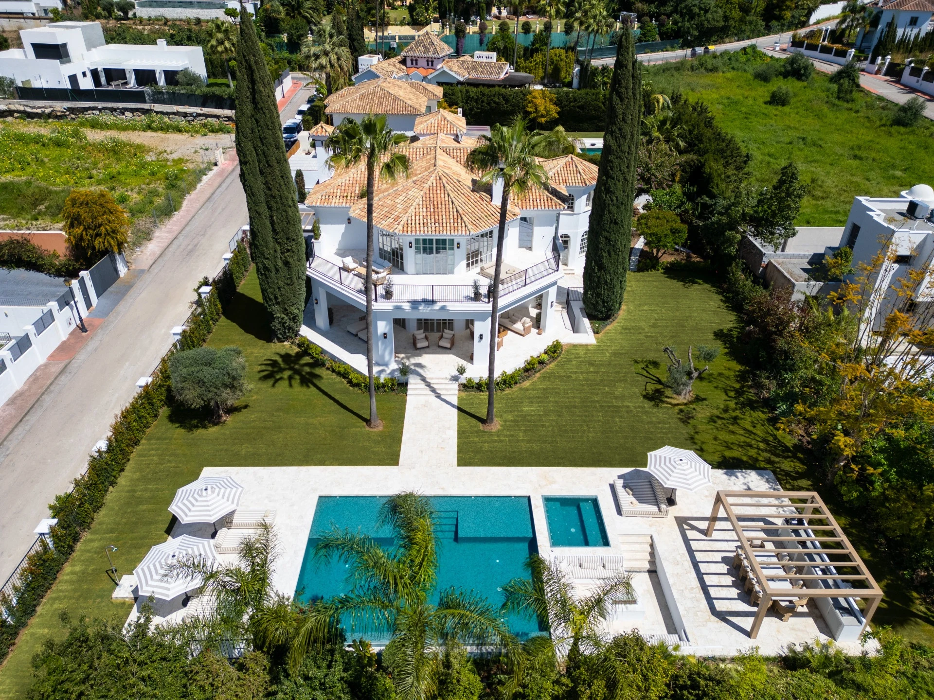 Aerial view of the villa, swimming pool and mature garden