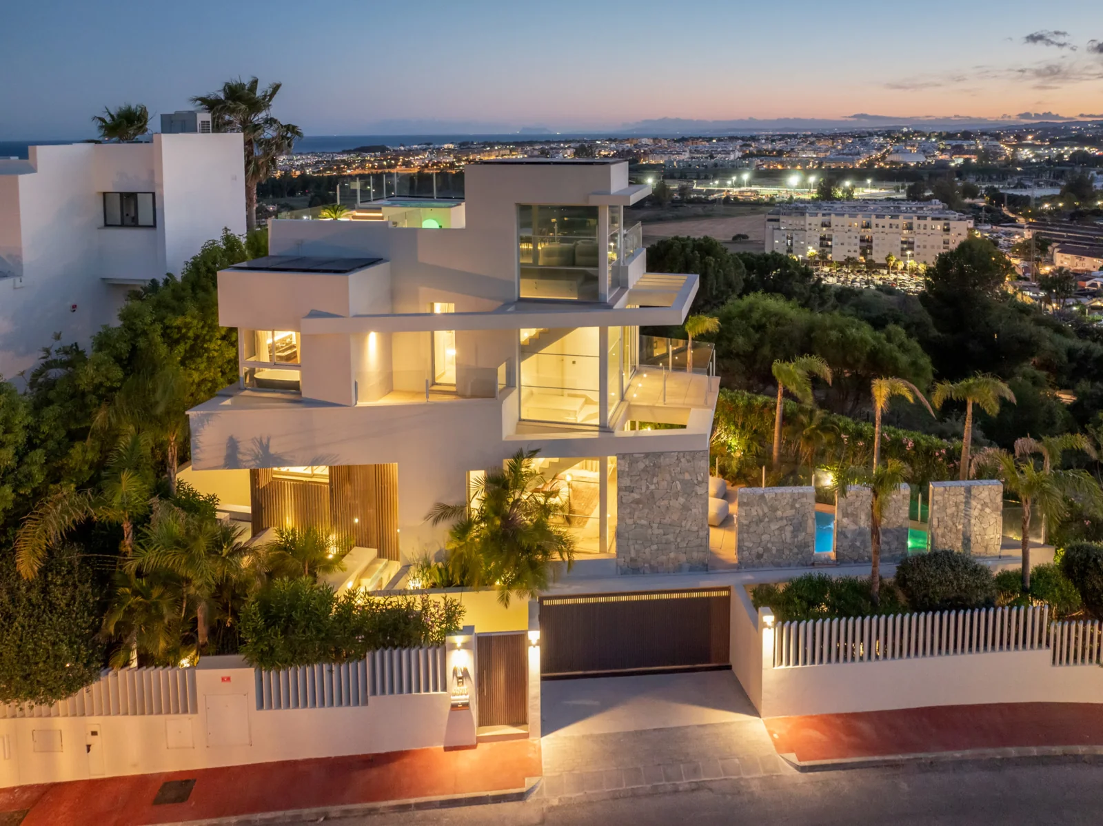 Contemporary villa exterior at dusk in Nueva Andalucia