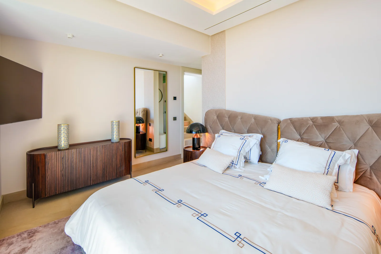 Principal bedroom with warm neutral finishes