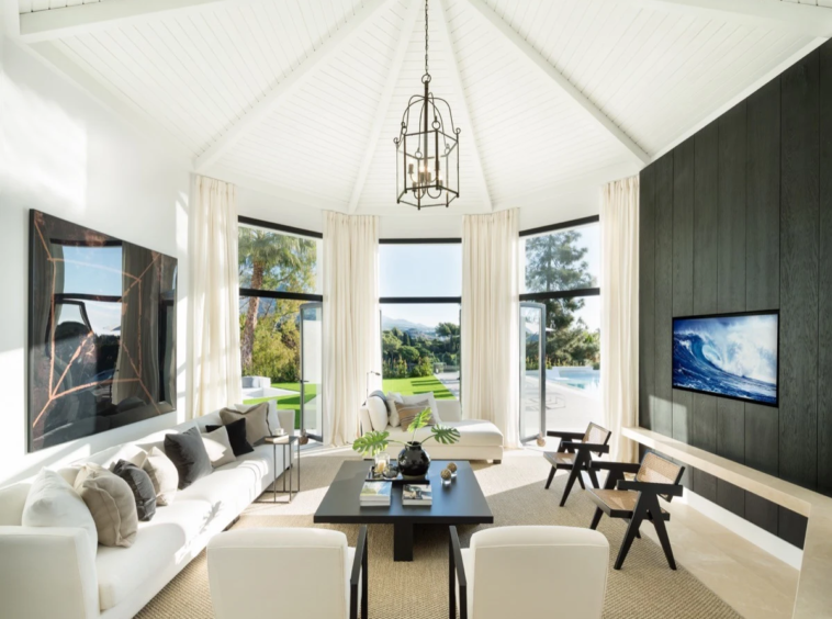 Hexagonal living room with high ceiling and fireplace