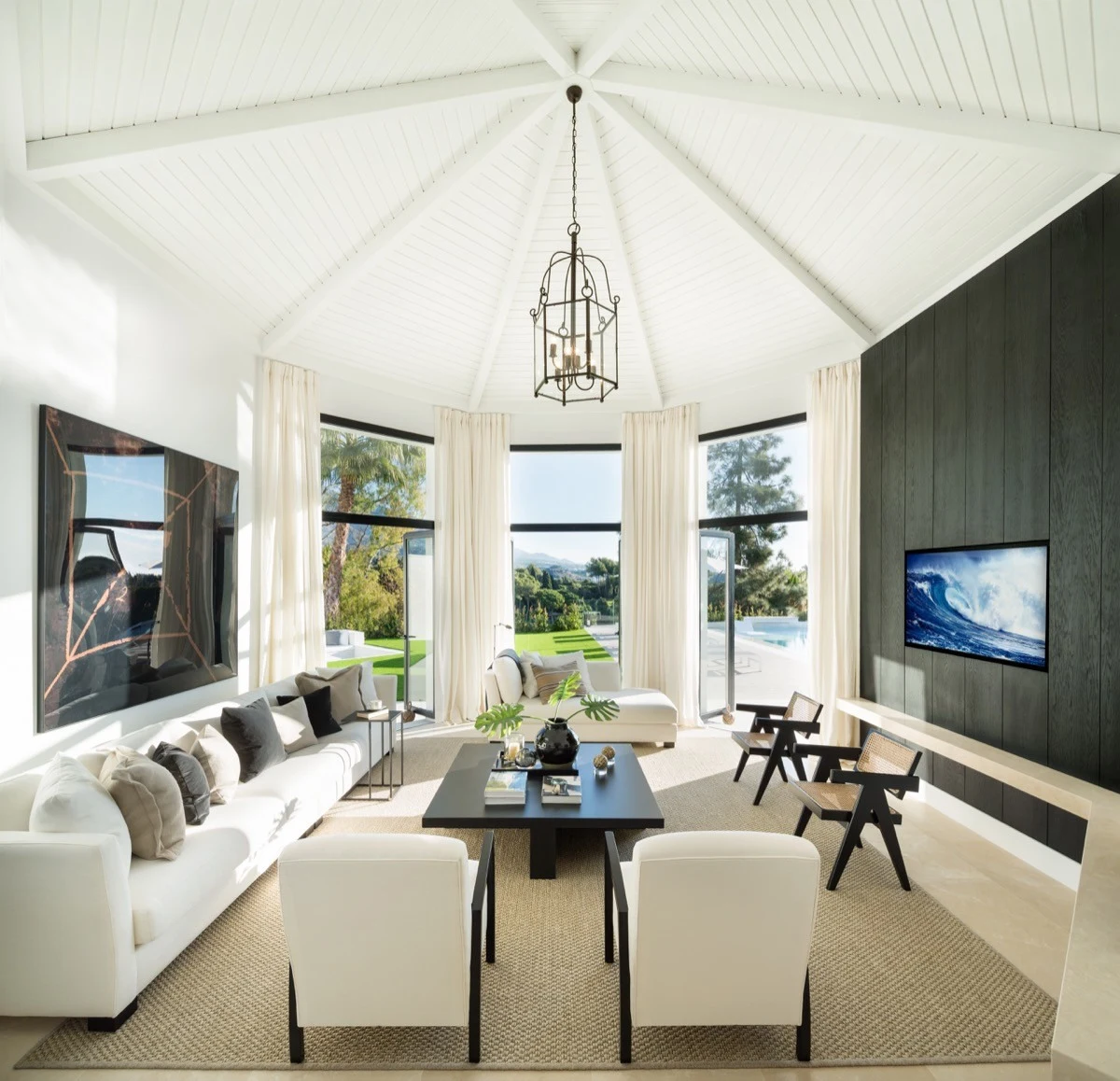 Hexagonal living room with high ceiling and fireplace