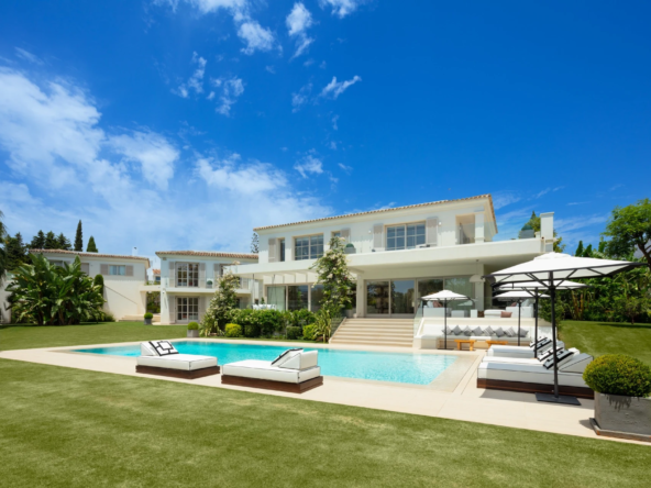 Villa exterior with private swimming pool and landscaped lawn