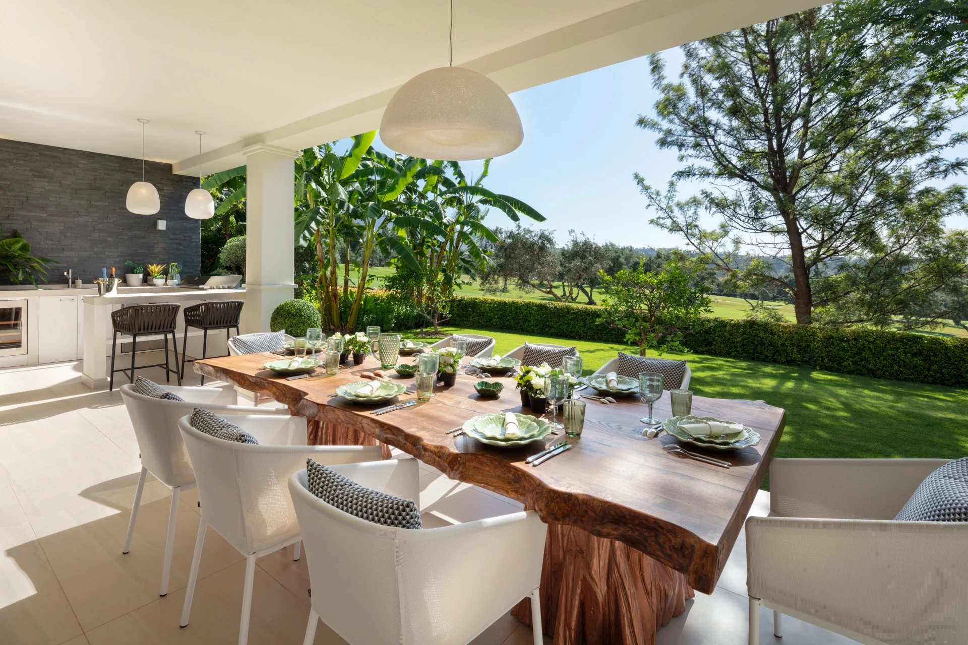Outdoor dining table overlooking the landscaped garden