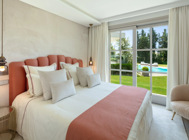 Bedroom with pink accents and garden views