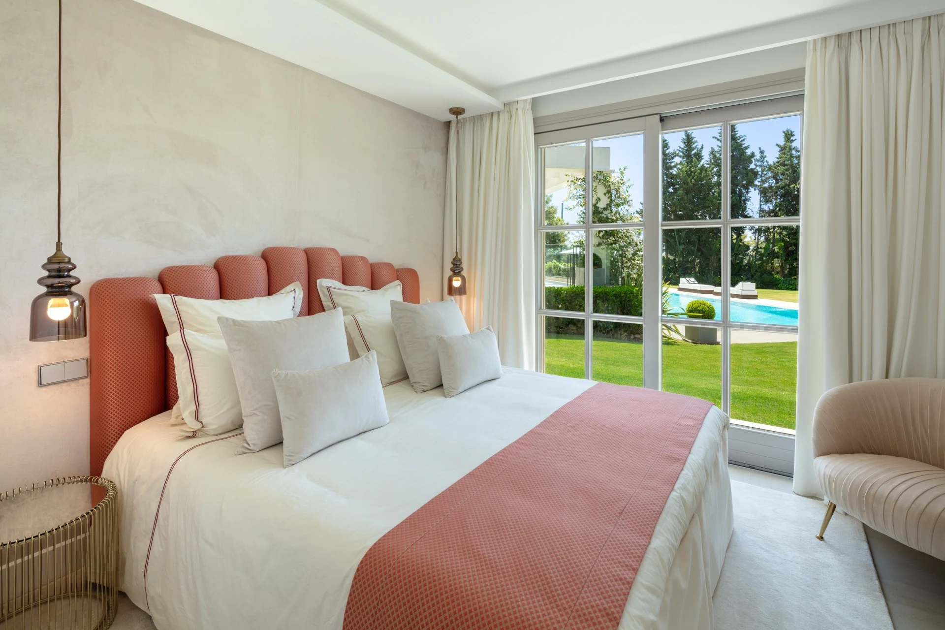 Bedroom with pink accents and garden views
