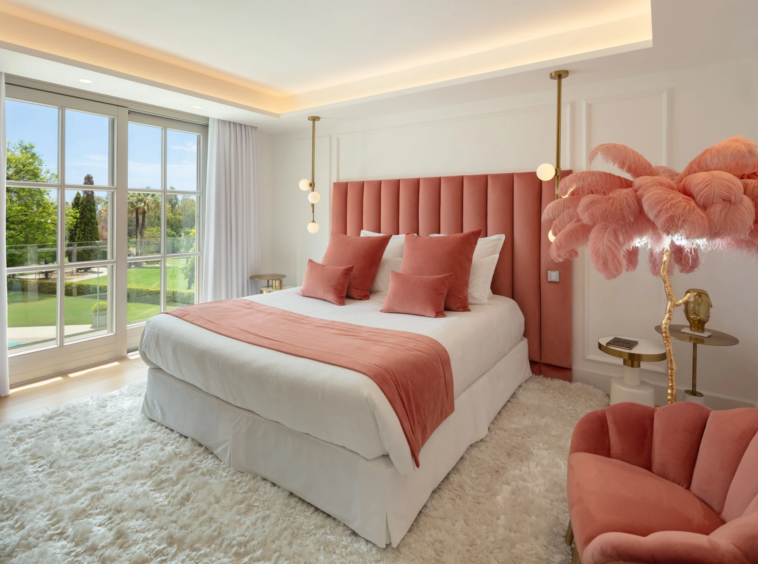 Bedroom with coral headboard and garden outlook