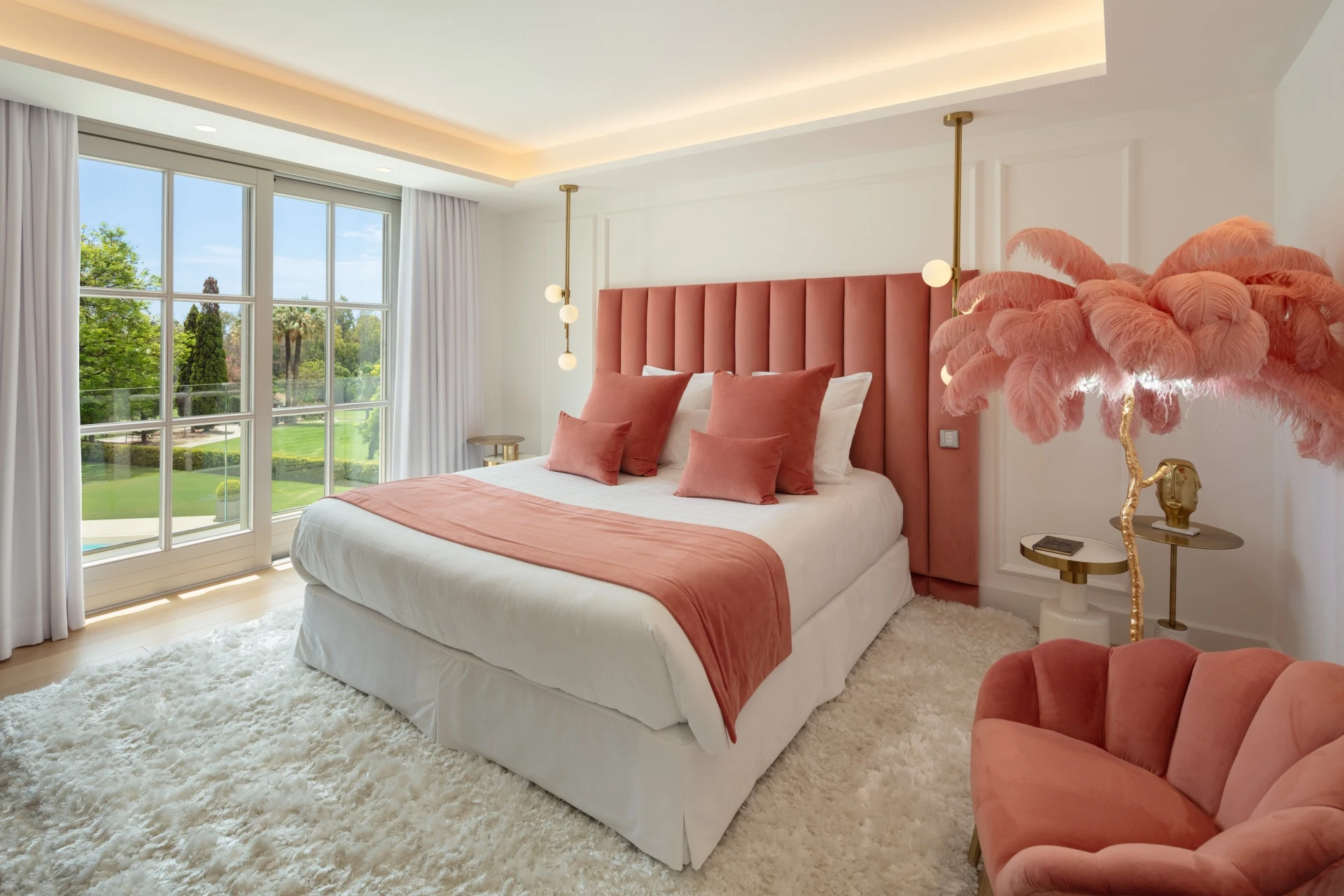 Bedroom with coral headboard and garden outlook