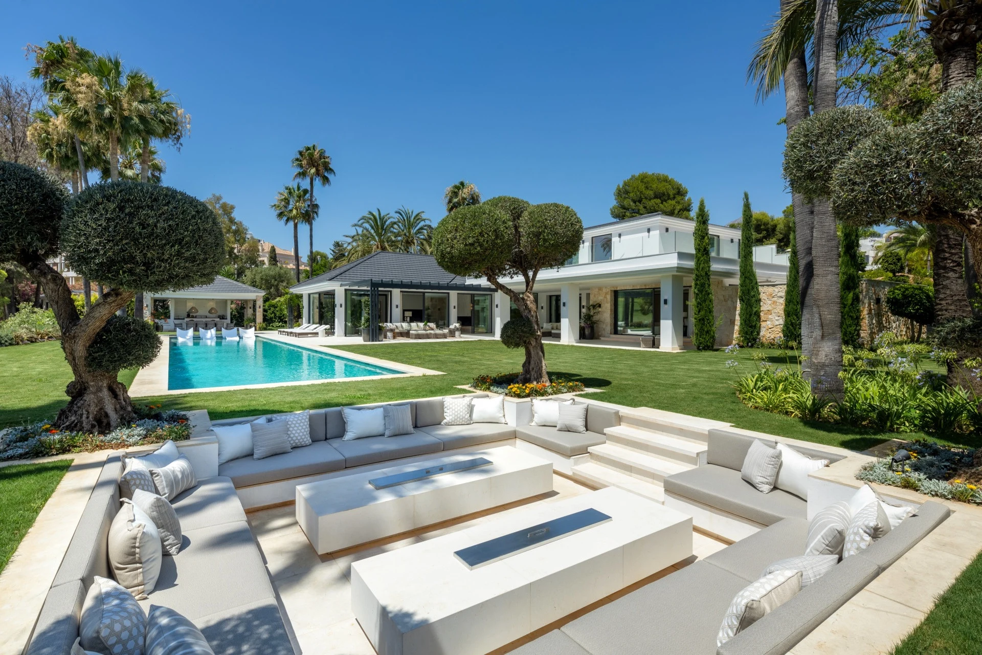 Private outdoor pool and sunken seating area in a landscaped garden