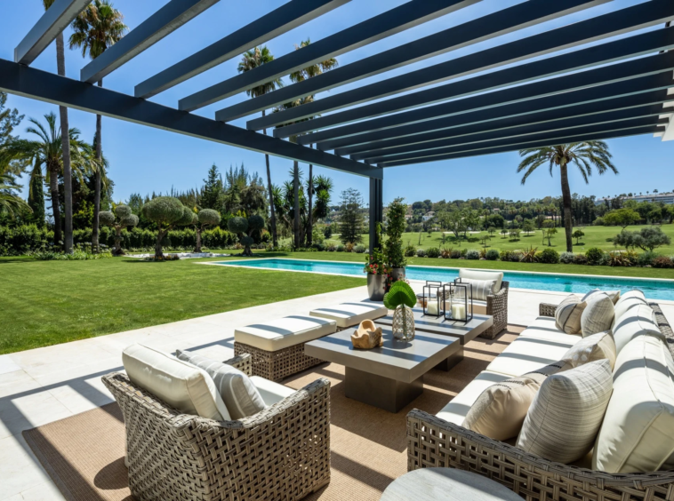 Covered terrace lounge overlooking the pool and golf course
