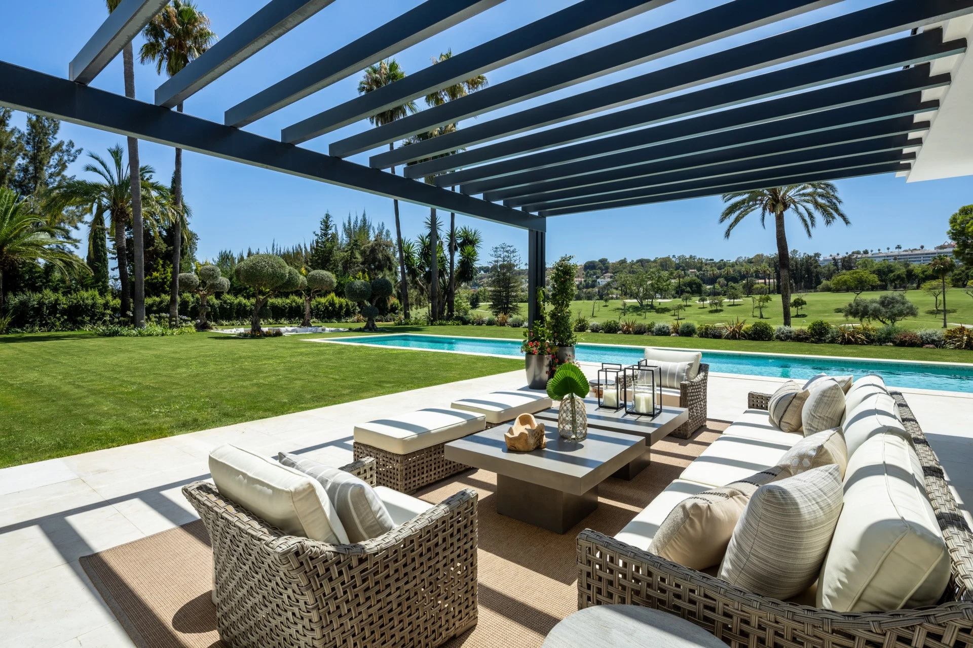 Covered terrace lounge overlooking the pool and golf course