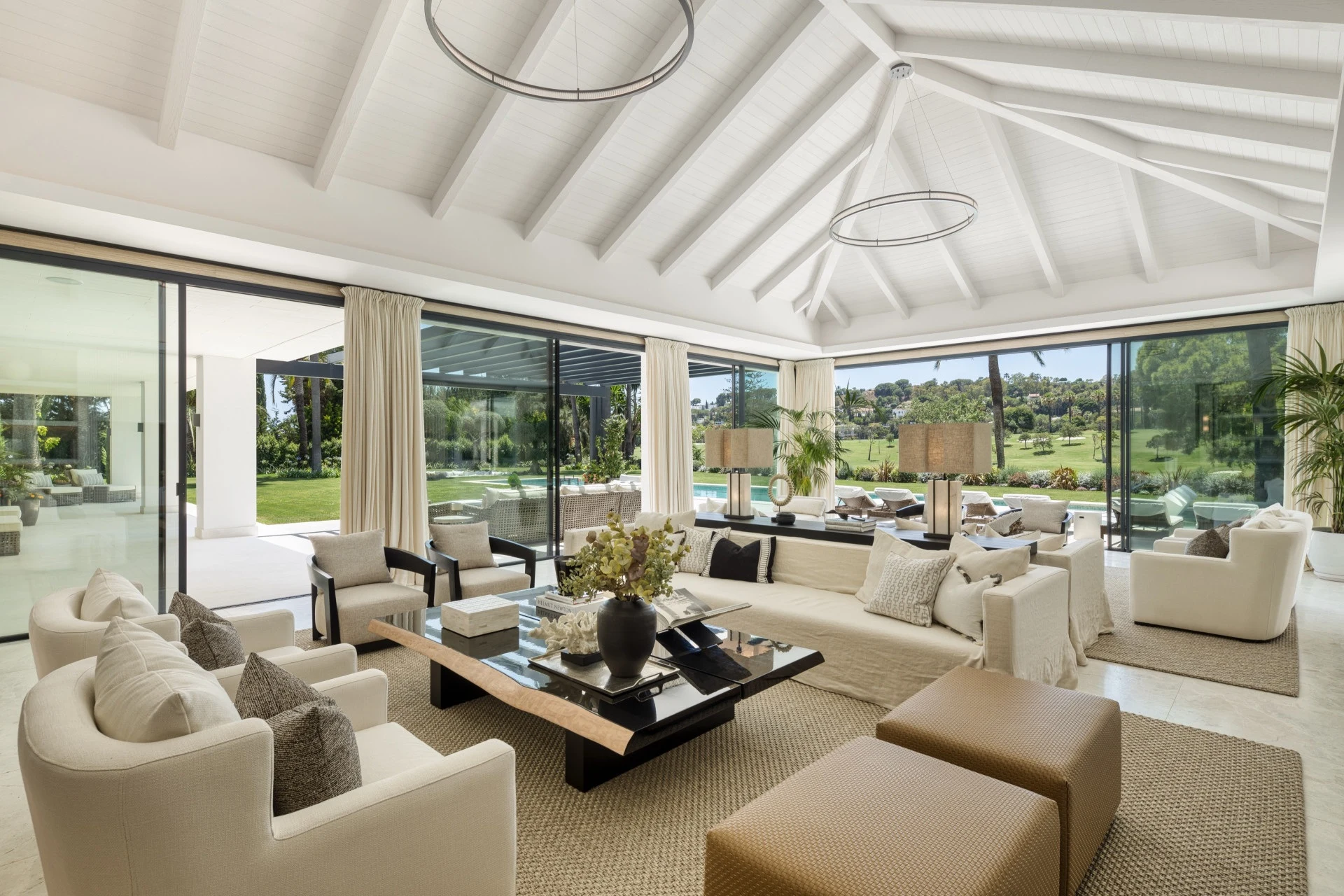 Bright living room with vaulted ceiling and full-height windows
