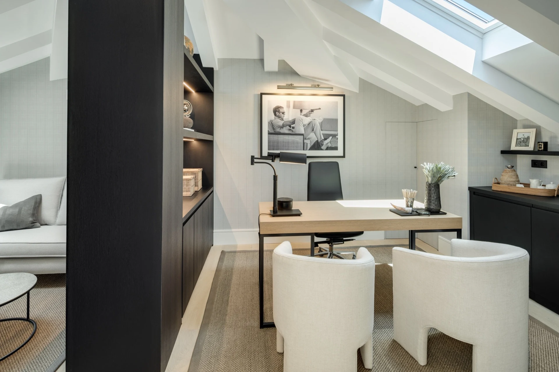 Home office beneath a sloping ceiling with built-in desk