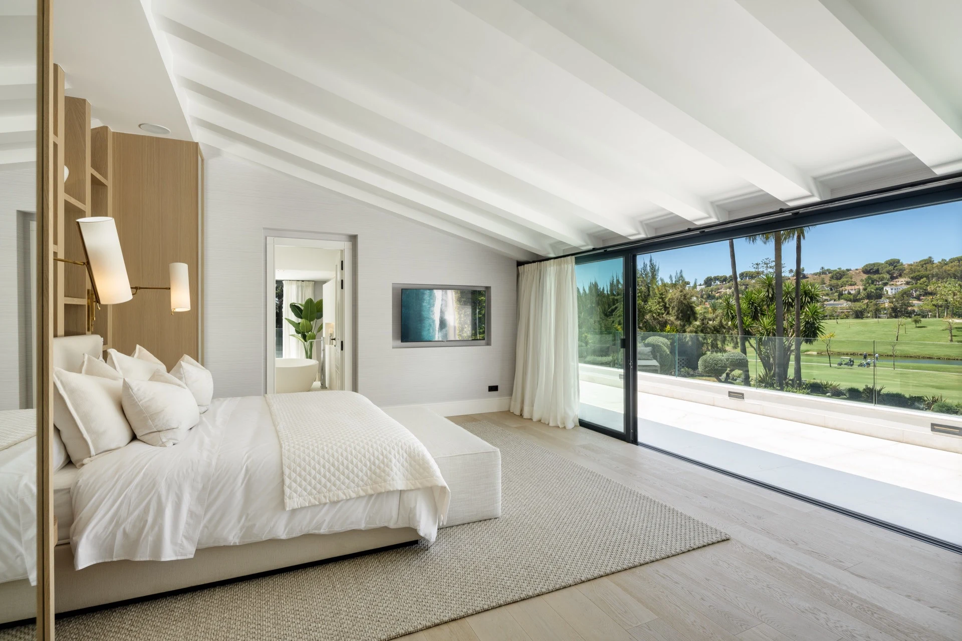 Principal bedroom opening to a golf-view terrace