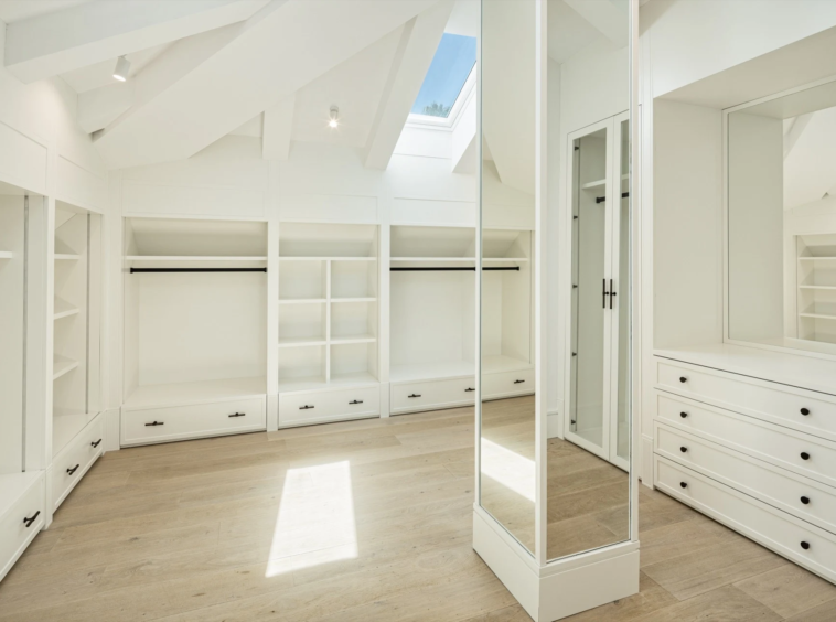 Walk-in dressing room with fitted wardrobes and central storage