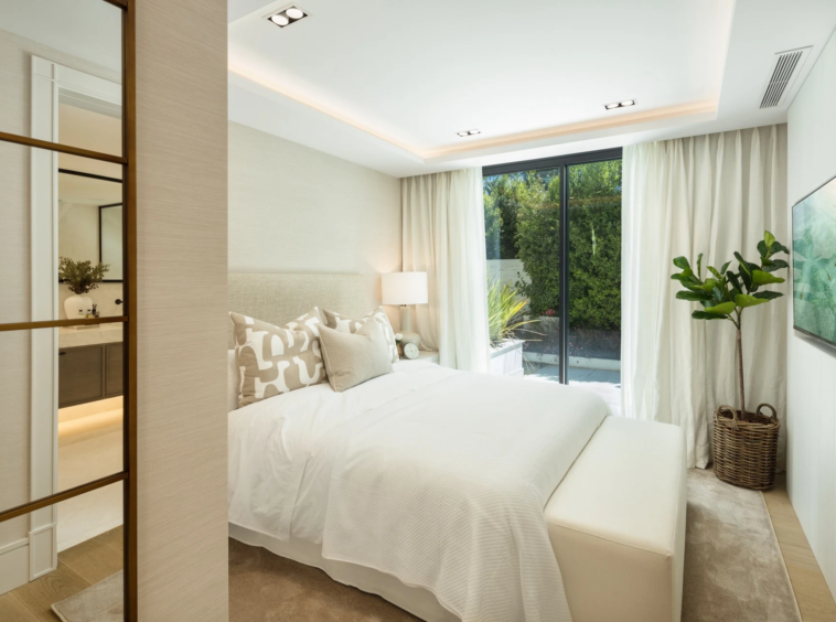 Guest bedroom with garden-facing window and neutral finishes