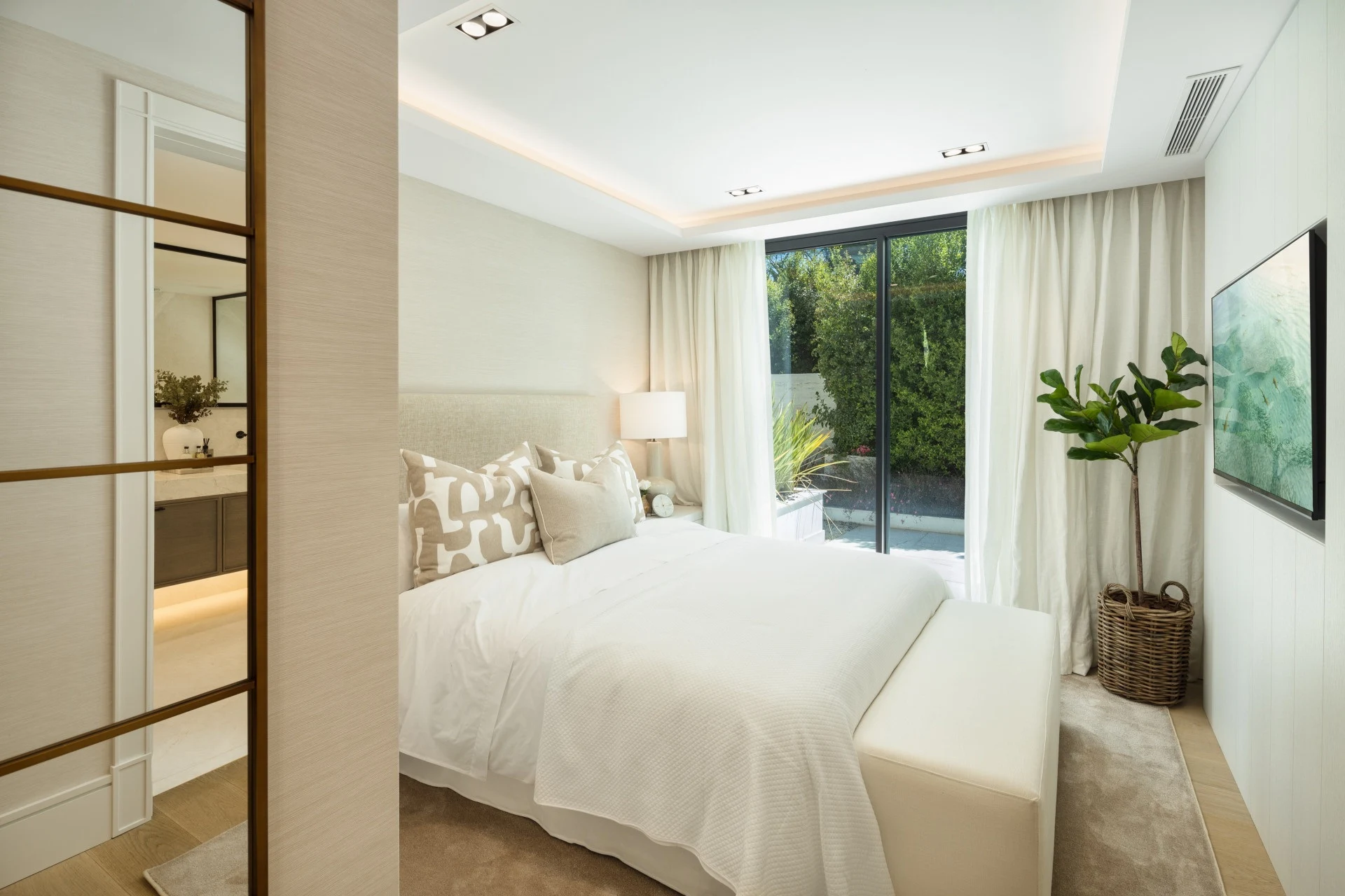 Guest bedroom with garden-facing window and neutral finishes