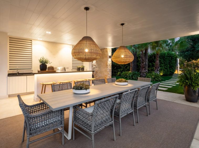Covered outdoor dining area with bar and garden outlook