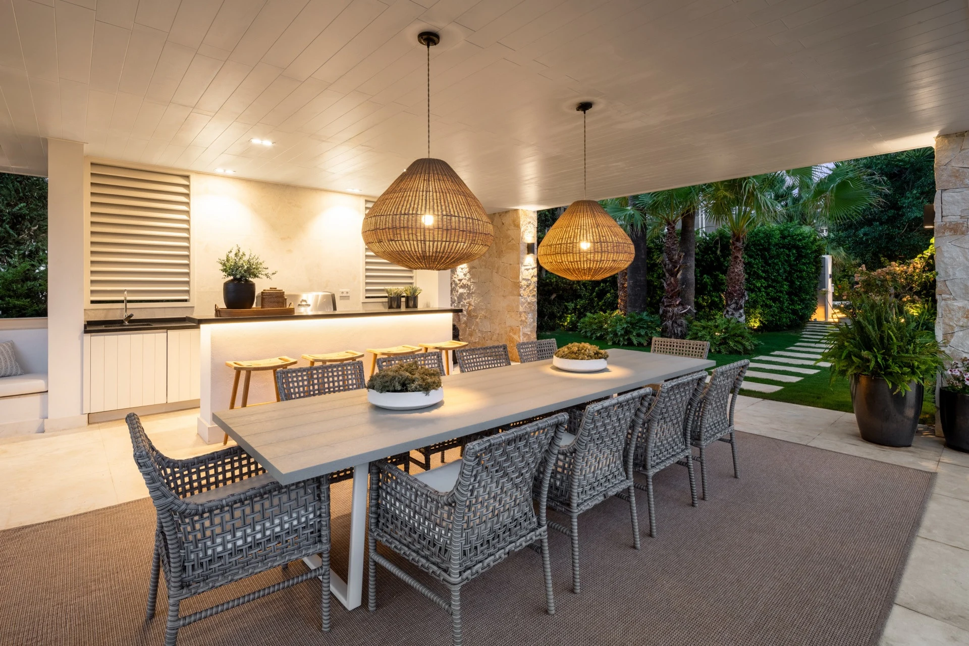 Covered outdoor dining area with bar and garden outlook