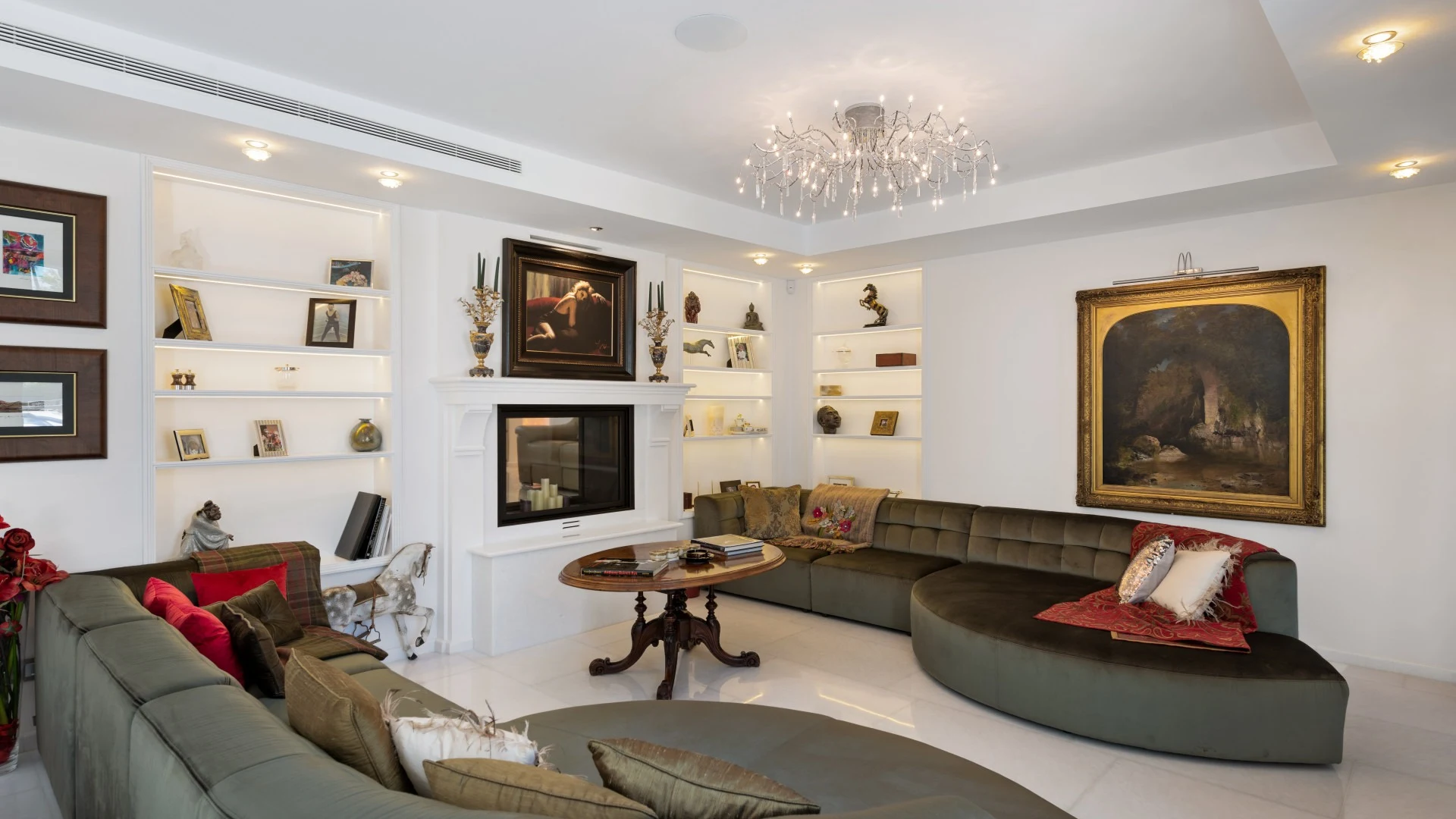 Living room with fireplace and curved sofas