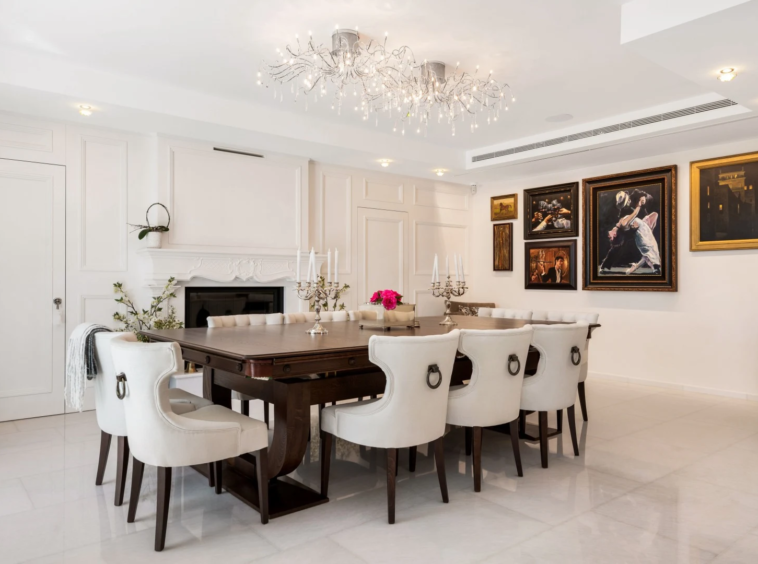 Formal dining room with chandeliers and fireplace