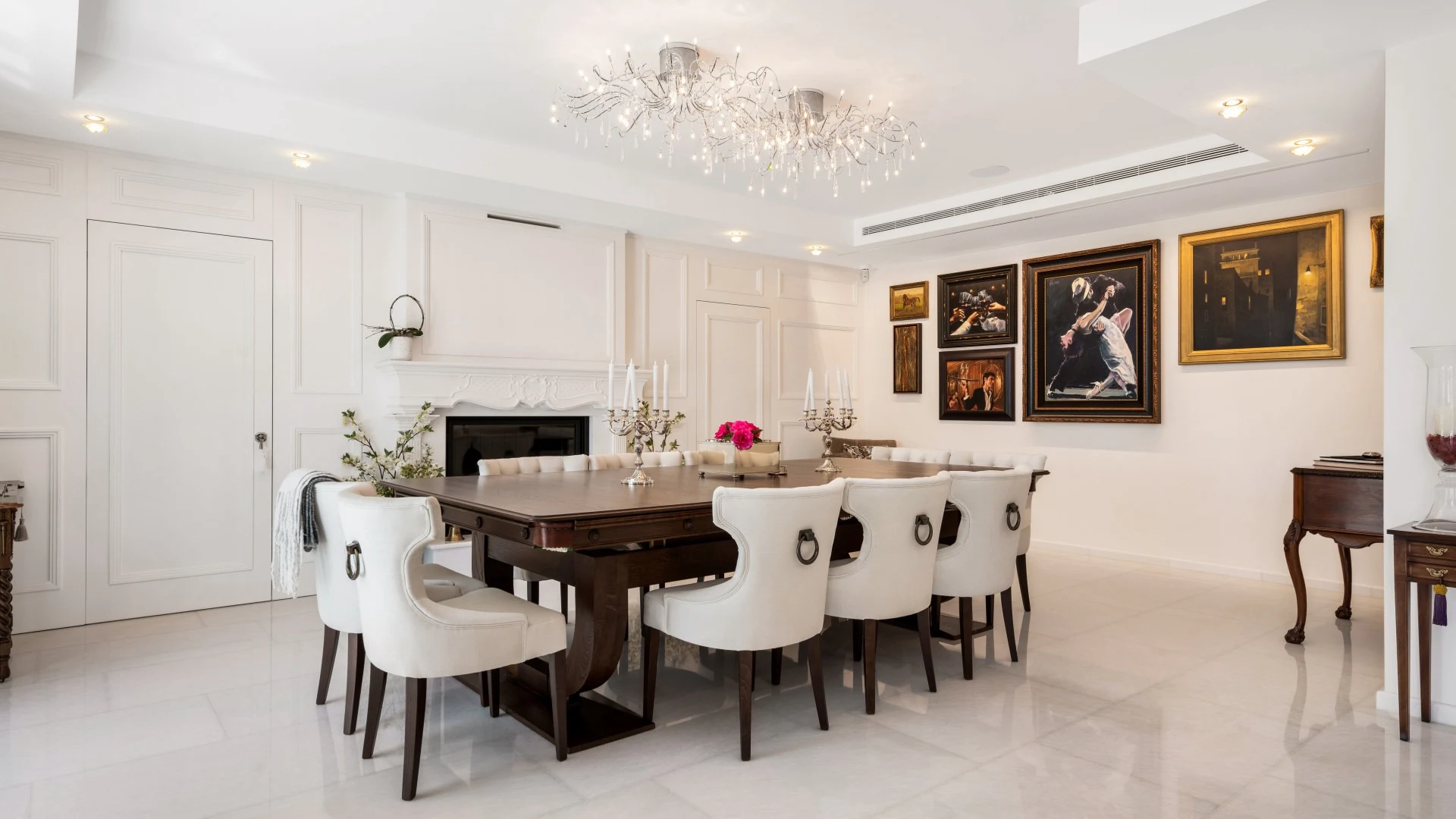 Formal dining room with chandeliers and fireplace
