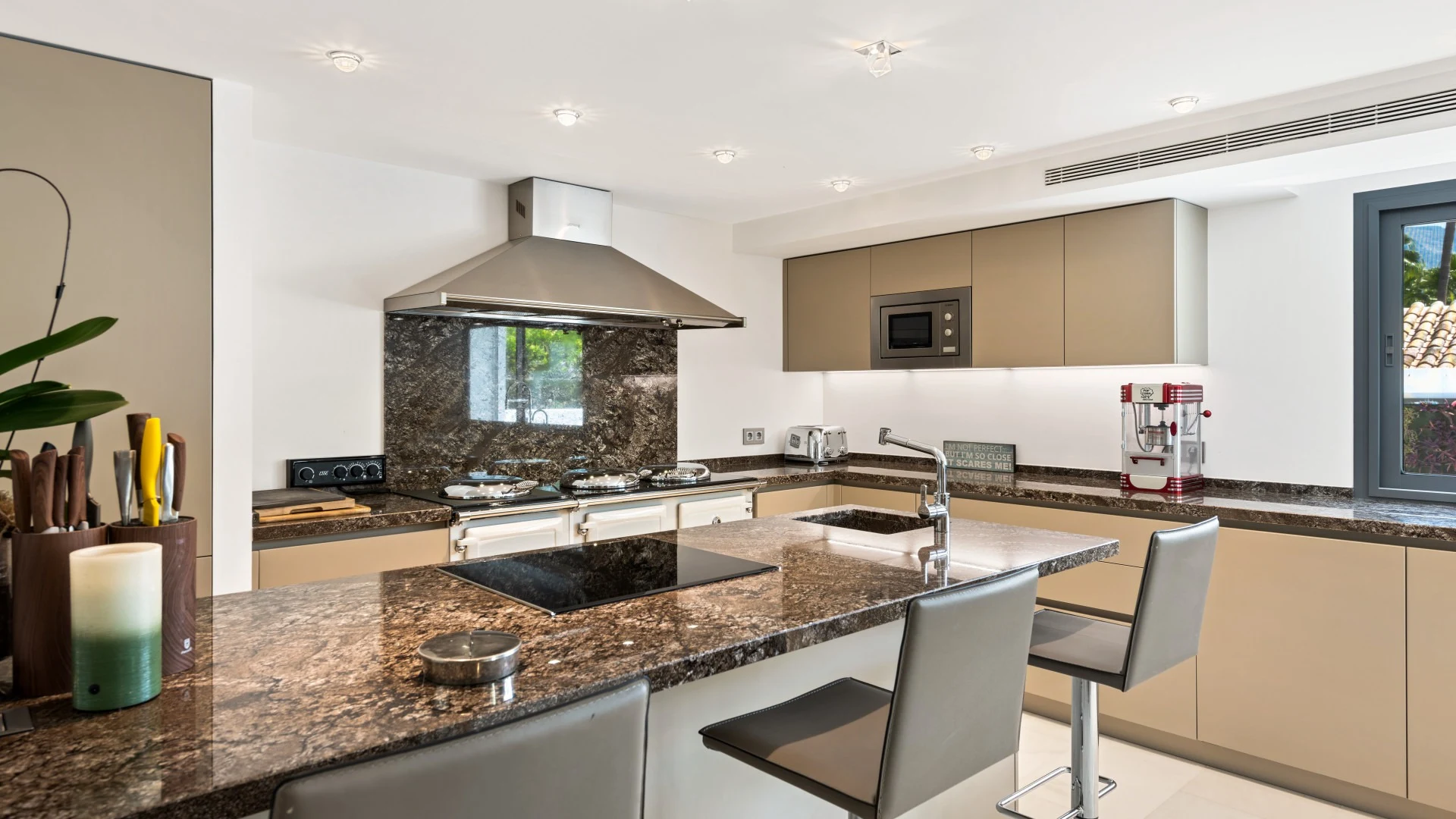 Modern kitchen with stone worktops and island