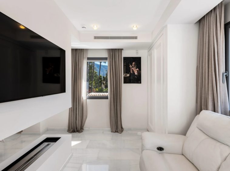 Private television lounge with garden-facing windows