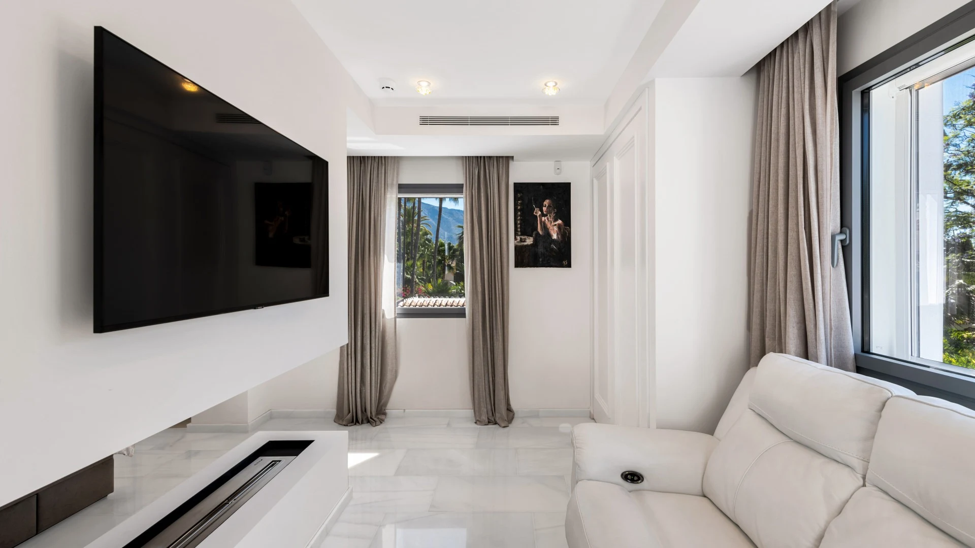 Private television lounge with garden-facing windows