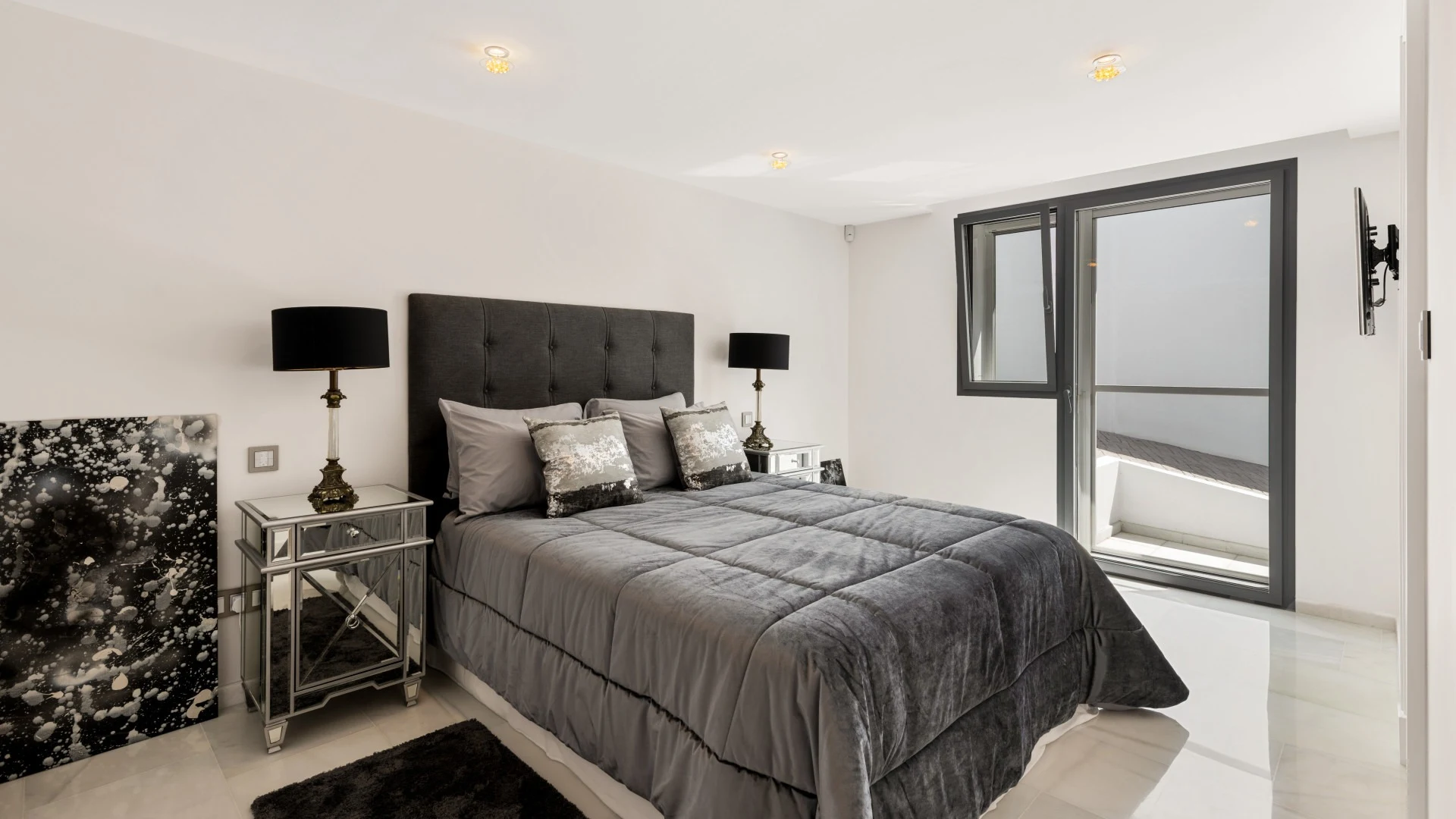 Guest bedroom with upholstered bed and large window