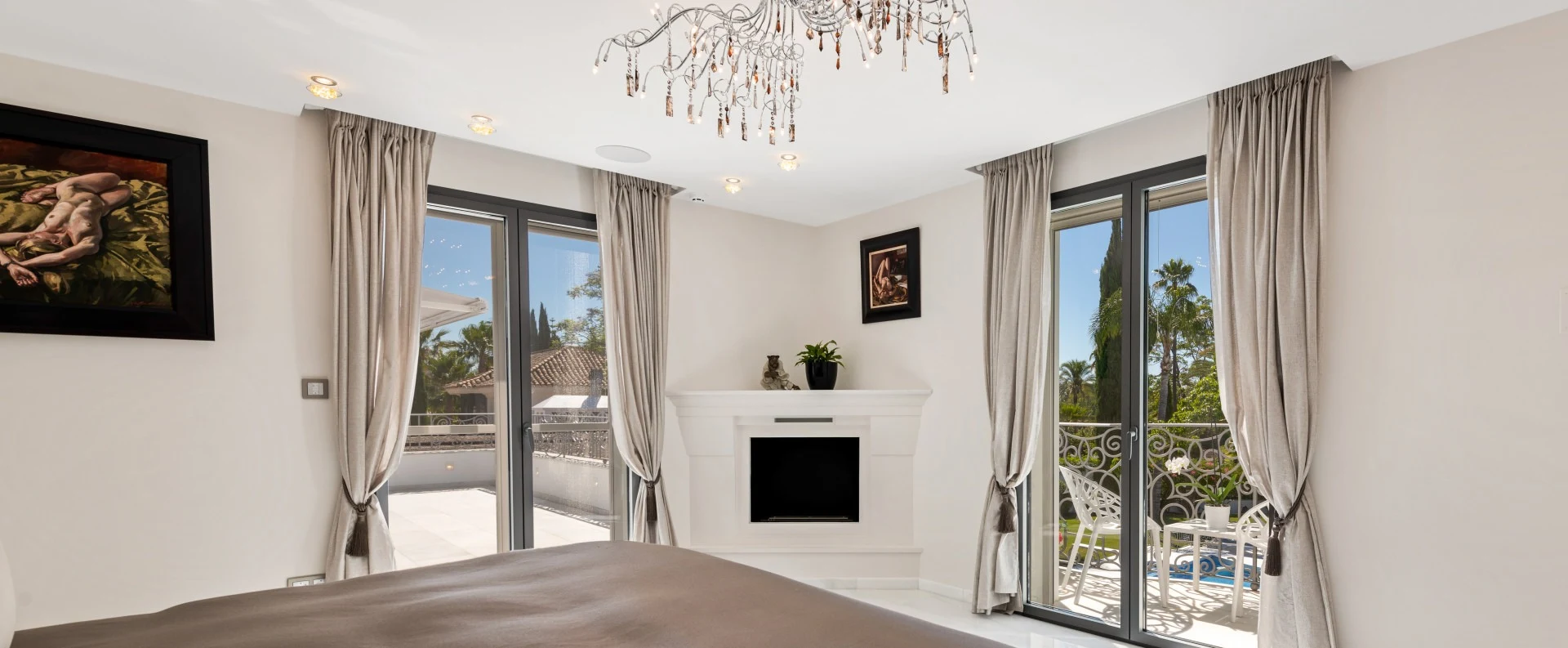 Principal bedroom with fireplace and terrace doors