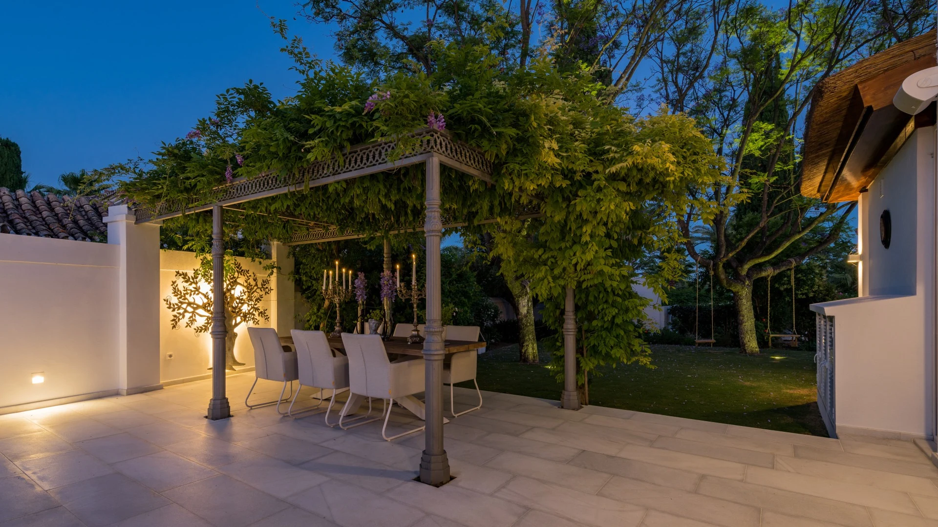 Outdoor dining area beneath a garden pergola
