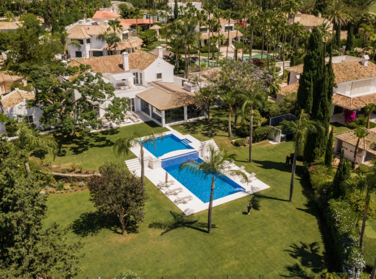 Wide view of the villa within its mature private garden