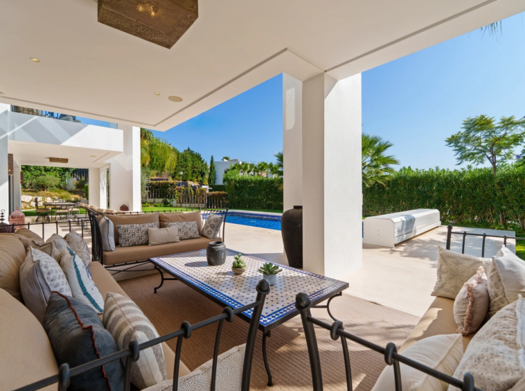 Covered lounge terrace beside the private swimming pool