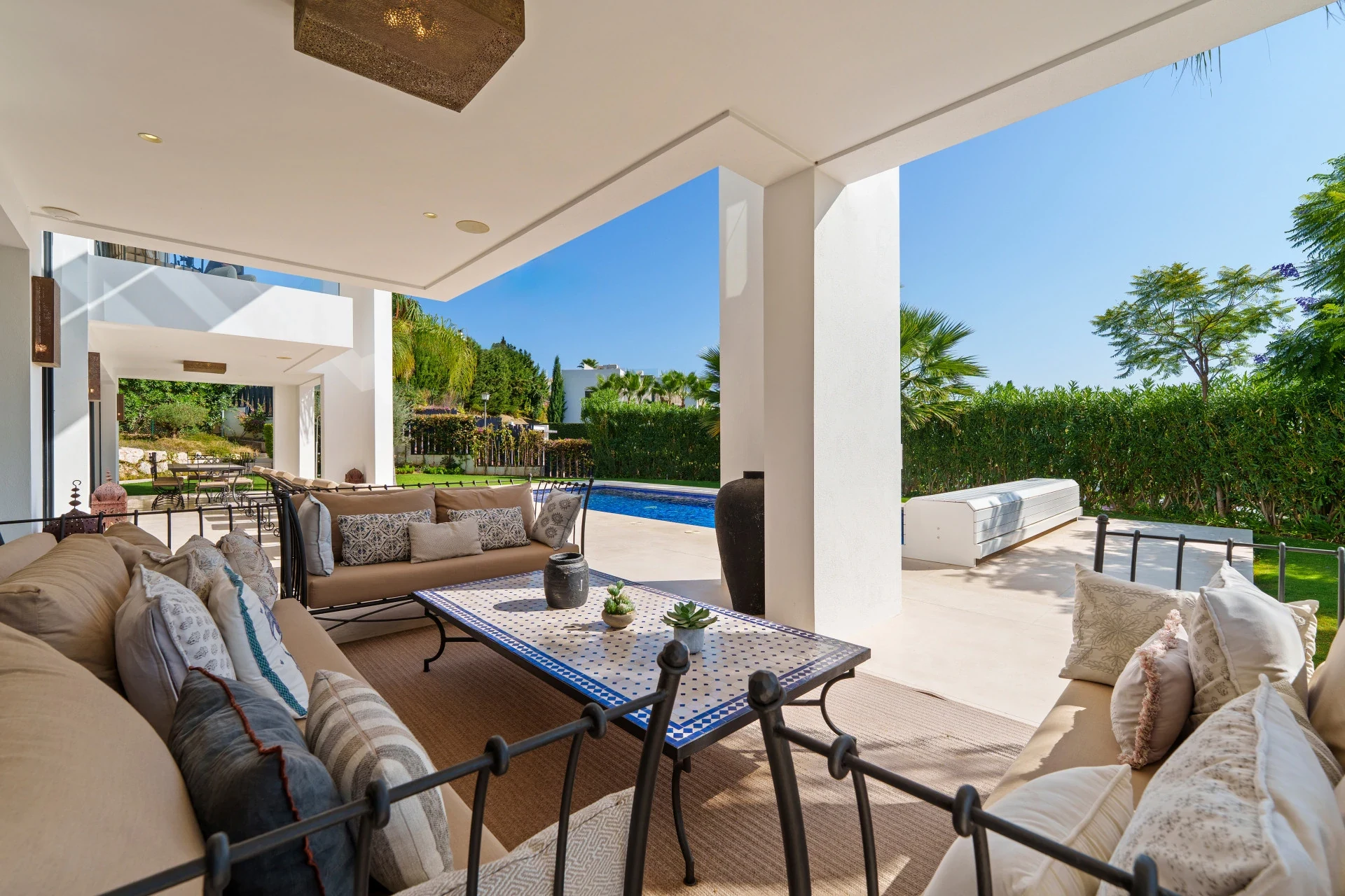 Covered lounge terrace beside the private swimming pool