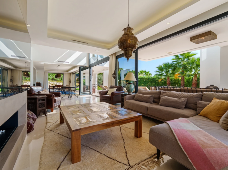 Bright living room with fireplace and terrace doors