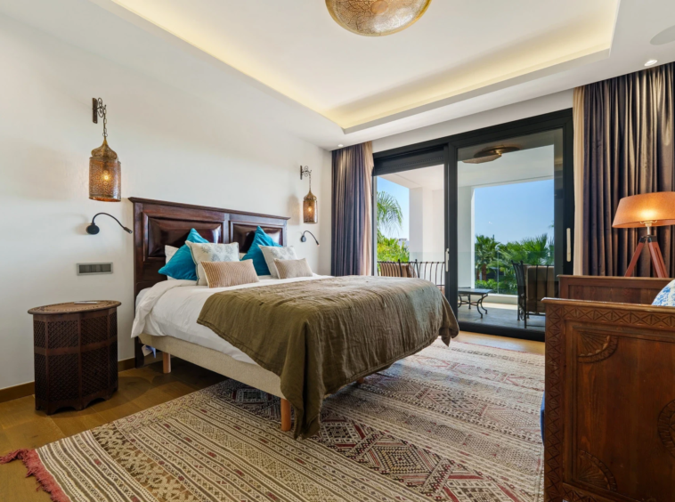 Bedroom with terrace access and warm interior finishes