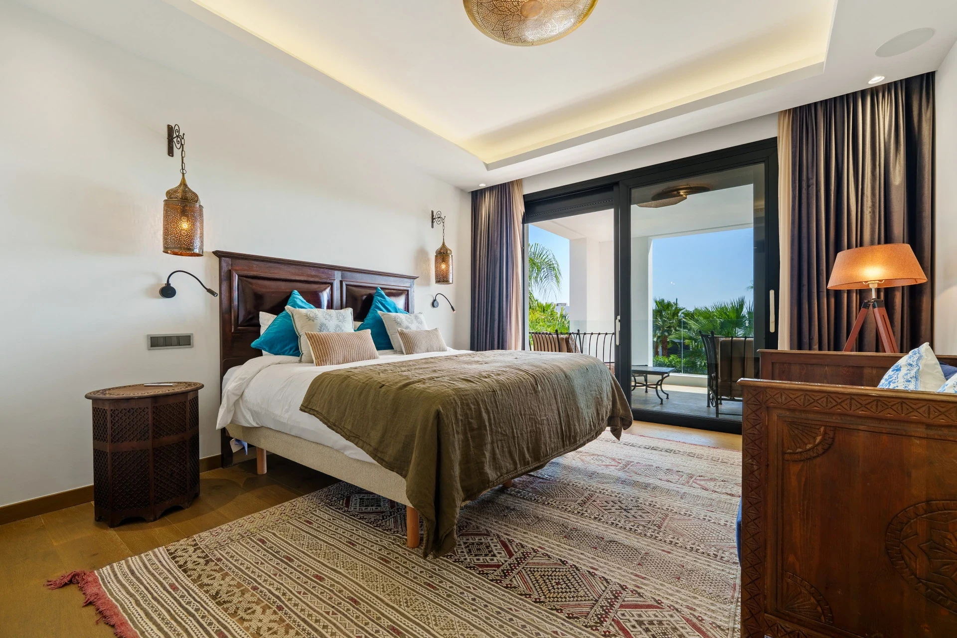 Bedroom with terrace access and warm interior finishes