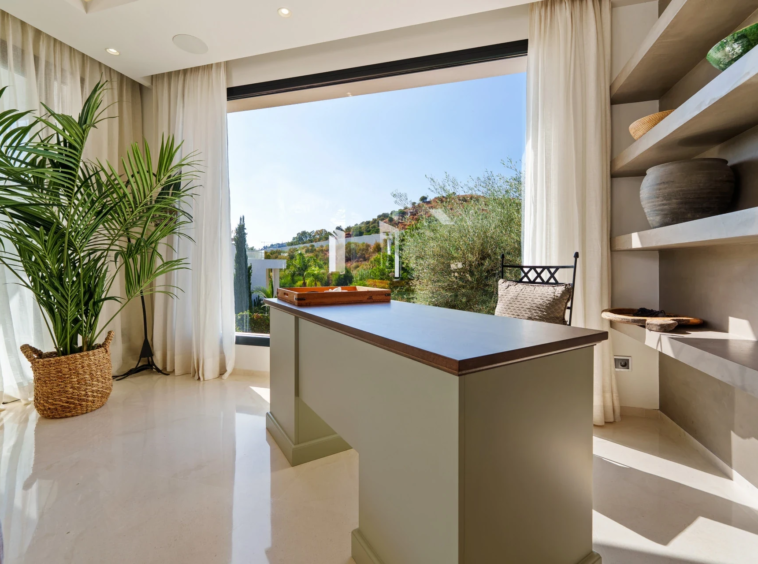 Home workspace beside a large window