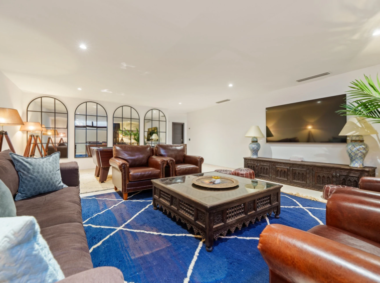 Cinema lounge with large screen and comfortable seating