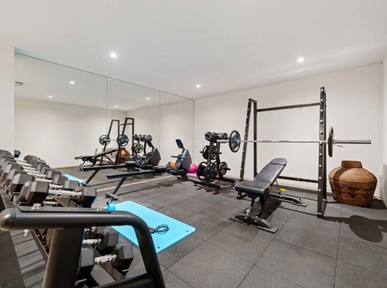 Private gym with weights and exercise equipment