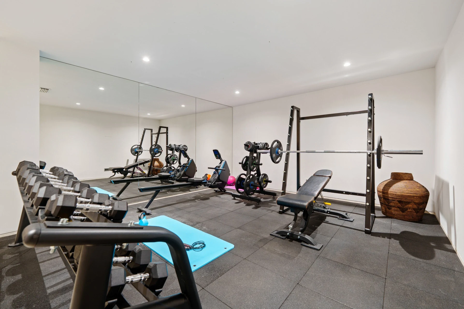 Private gym with weights and exercise equipment