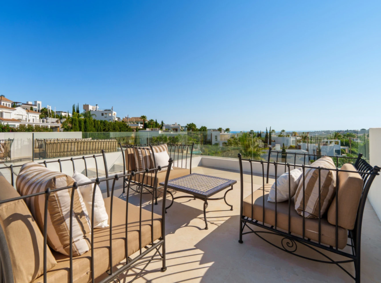 Rooftop terrace with seating and views towards the coast