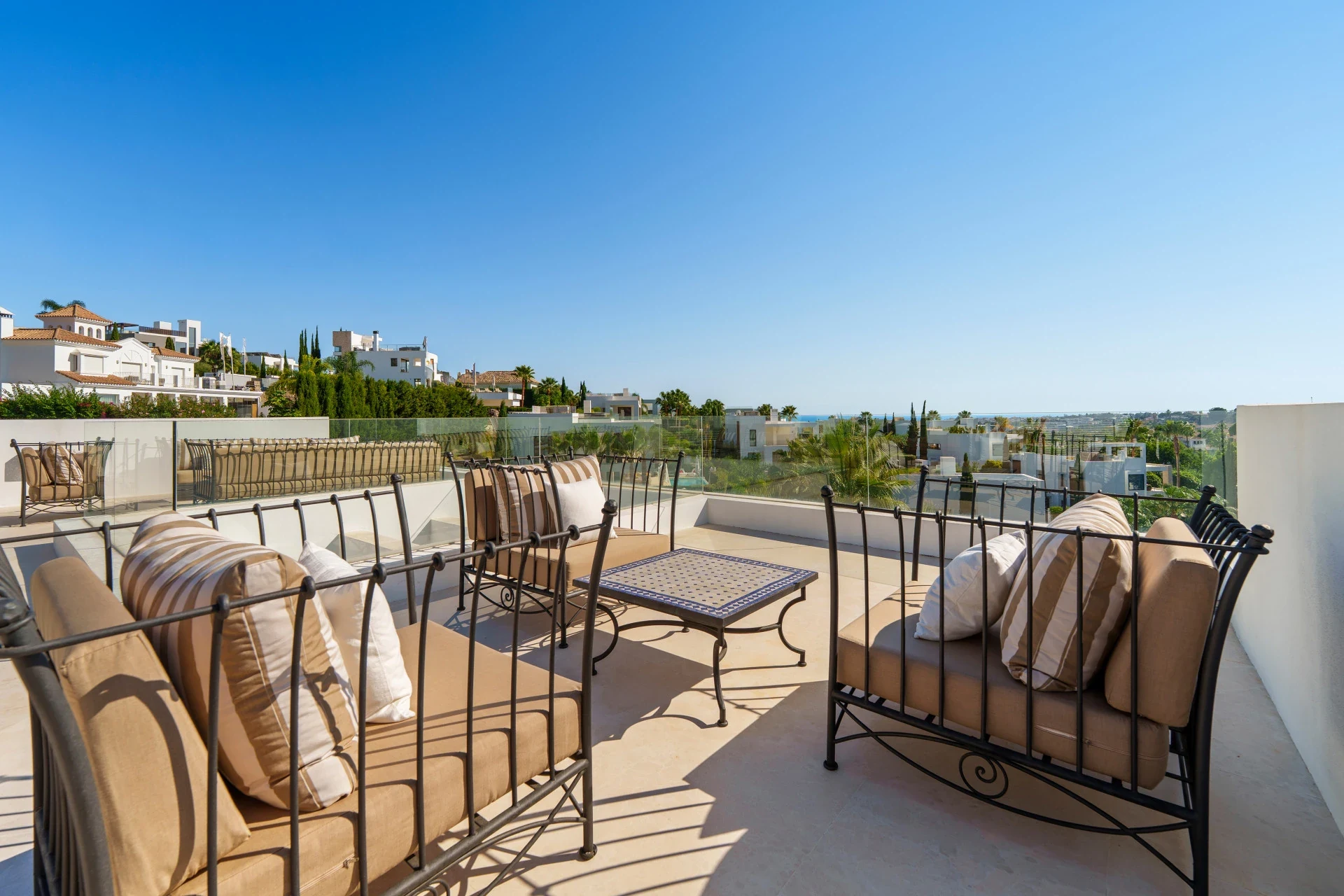 Rooftop terrace with seating and views towards the coast