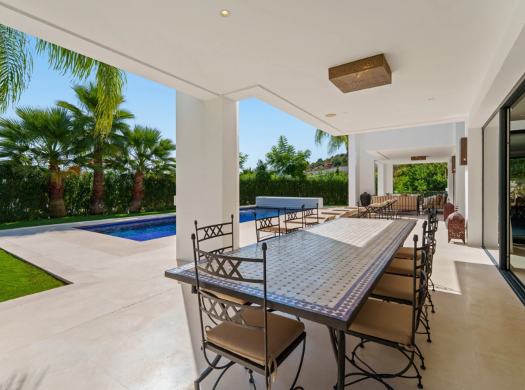 Covered outdoor dining terrace overlooking the pool