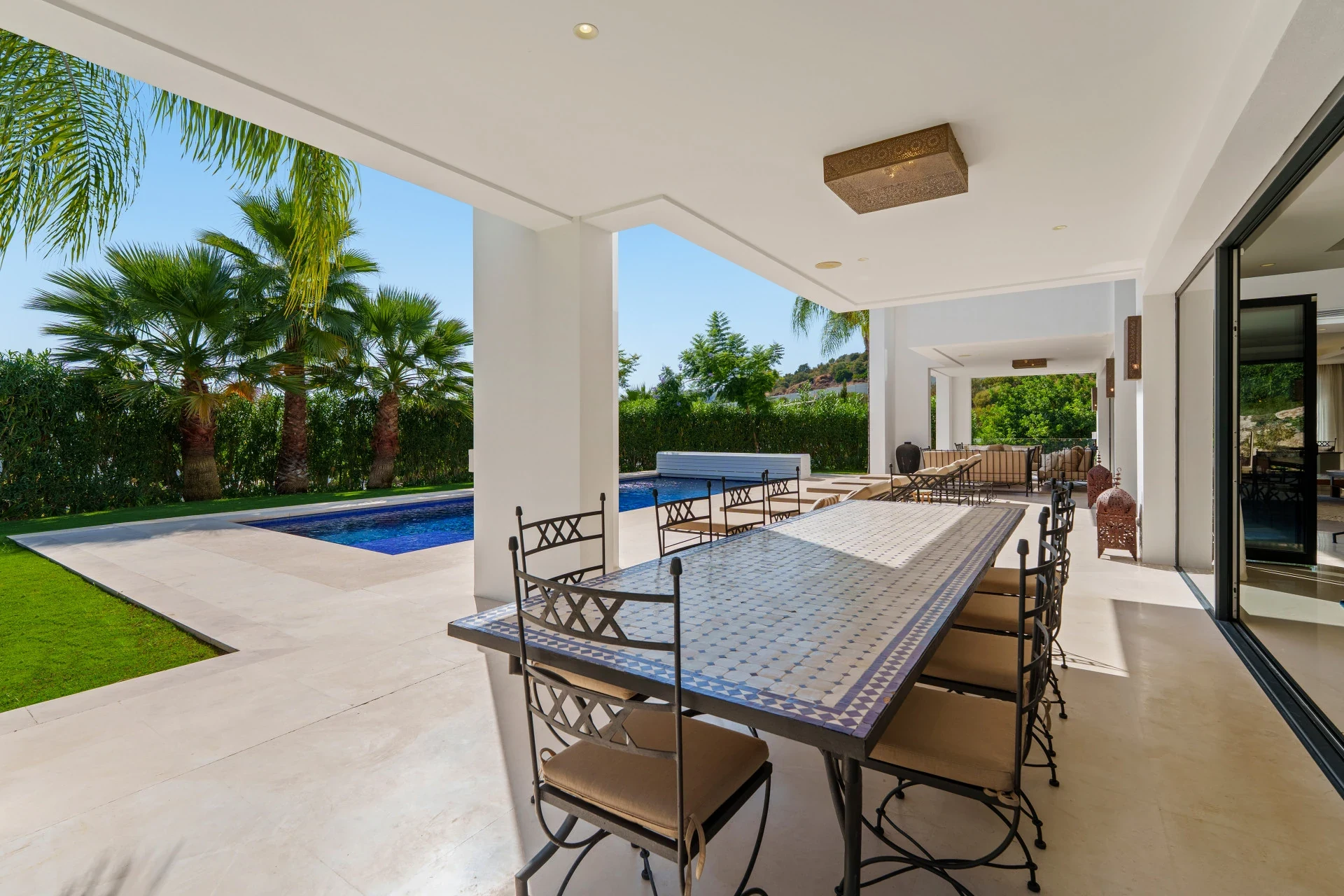 Covered outdoor dining terrace overlooking the pool