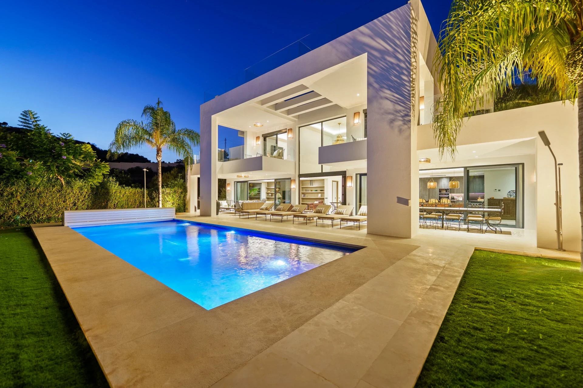Illuminated villa and private swimming pool in the evening